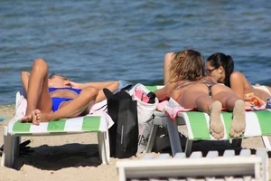 A couple sexy girls laying out on the beach