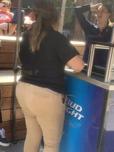 Bunch of girls in various outfits at a Cardinals baseball game