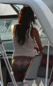 Bikini babe on a boat with a wet see through white shirt showing her tits