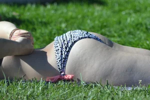 Cute blonde teen laying out in her bikini