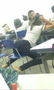 Candid Girl in Pants Sitting on a Chair With Widely Spread Legs Classroom Photo