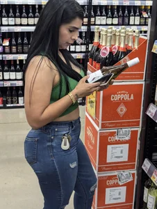 Sexy Latina buying wine