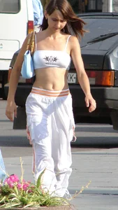 Cute flat-chested candid girl in a top with a wonderful tummy
