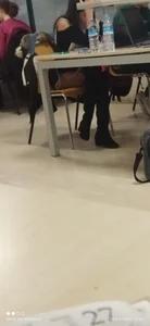 Sexy Candid Girl in a Short Dress And Knee High Boots Sitting With Crossed Legs at the Library Creepshot