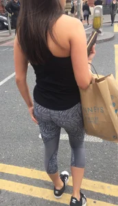Sexy girl walking in grey patterned leggings with friend in tight jeans