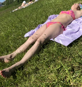 Candid girls in swimsuits chilling on the grass