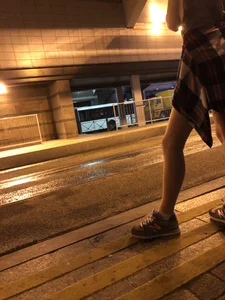 Cute Teen in Shorts on the Tram Stop