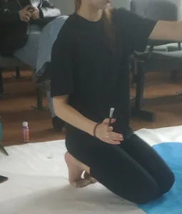 Skinny teen painting on the floor