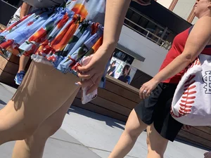 Bunch of girls in various outfits at a Cardinals baseball game