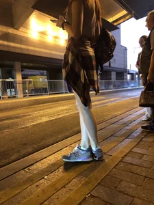 Cute Teen in Shorts on the Tram Stop
