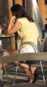 Lady in flop flops while eating showing her feet
