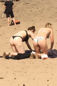 Big boobed babe at the lake in a black thong with blonde friend