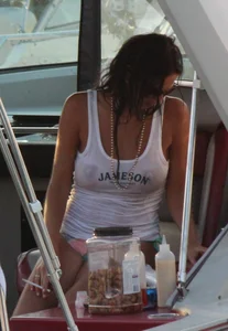 Bikini babe on a boat with a wet see through white shirt showing her tits
