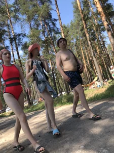 Young Girl in a One-Piece Swimsuit Walking on a Forest Road Photo Gallery