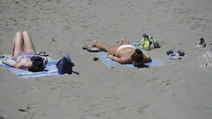 Sexy beach girl laying out in white bikini with nice body