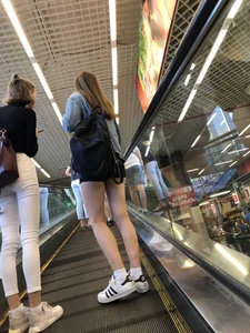 Hot Girls on the Mall Travelator in Mini Shorts and Her Friend in White Pants - Skinny Hot Legs Creepshots