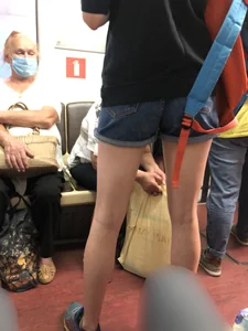 Girl in Shorts Standing in a Subway Train With Spread Legs - Creepshots Gallery