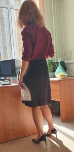 Hot teacher wearing stiletto heels and a skirt in classroom