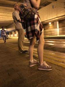 Cute Teen in Shorts on the Tram Stop