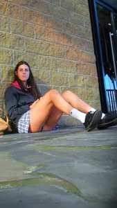 Girl Sitting on the Floor in a Skirt Revealing Panties While Standing Up