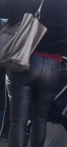 Milf shows off her shapely ass in her leather pants at the market