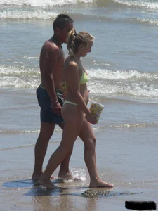 Sexy blonde on the beach in a yellow thong bikini