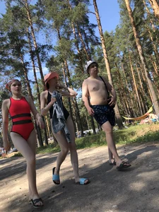 Young Girl in a One-Piece Swimsuit Walking on a Forest Road Photo Gallery