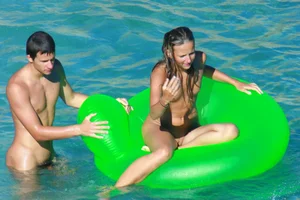 FKK Nudists playing in the water with floater