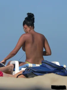 Hot ass topless beach girl with great tits lets her little brother oil up her ass in thong bikini