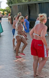 Big boobed blonde milf dancing by the pool in a bikini