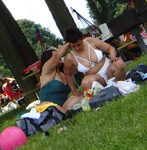 Big boobed brunette on the beach in white bikini