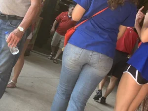 Bunch of girls in various outfits at a Cardinals baseball game