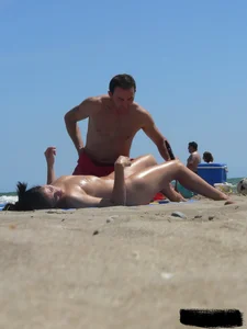 Purple thong topless lady on the beach gets oiled up by her husband