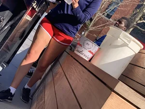 Bunch of girls in various outfits at a Cardinals baseball game