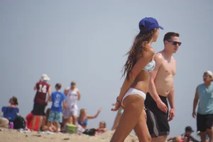 Beach football sexy brunette in white bikini