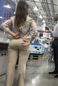 Plus Face shot - Gorgeous AT&T babe in beige pants  touching her ass with long red nails