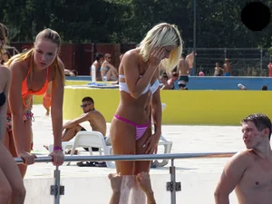 Tanned blonde looking sexy at the pool in thong