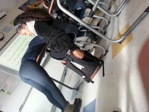 Girl in Tights Bending Over Desk in College Classroom Candid Photo