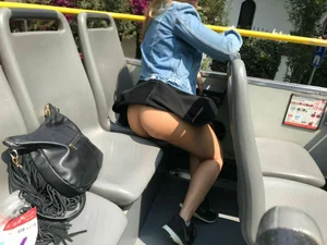 Girl in a public bus with her skirt jerked up by the wind