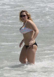 Big boobed thick blonde on the beach in a bikini