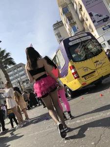 Hot carnival girl in in a top, mini shorts with pink frill and awesome legs in fishnet pantyhose