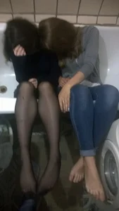 Teens in Black Pantyhose And Skinny Jeans Lying in a Bathtub Home Photo