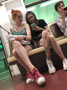 Two Girls With Hot Long Legs in Mini Shorts and Sneakers in the Subway Train Candid Photo Gallery