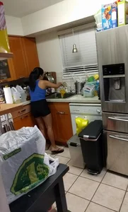Asian girlfriend doing dishes in spandex shorts