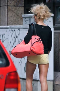 Blonde looking sexy walking in short yellow shorts