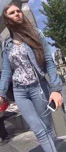 Another girl in tight jeans waiting for the bus