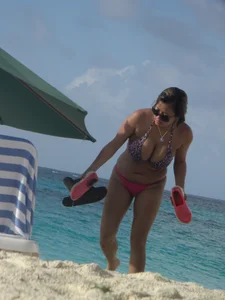 Lady with big tits wearing pink thong on the beach