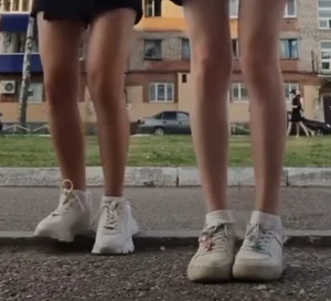 Slim Legs of Young Girls in Skirts And Sneakers Street Creepshot