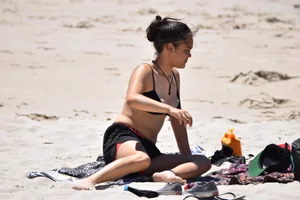 Beach girl can't keep her tits in her bikini