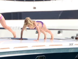 Avril Lavinge looking sexy in purple bikini on a boat